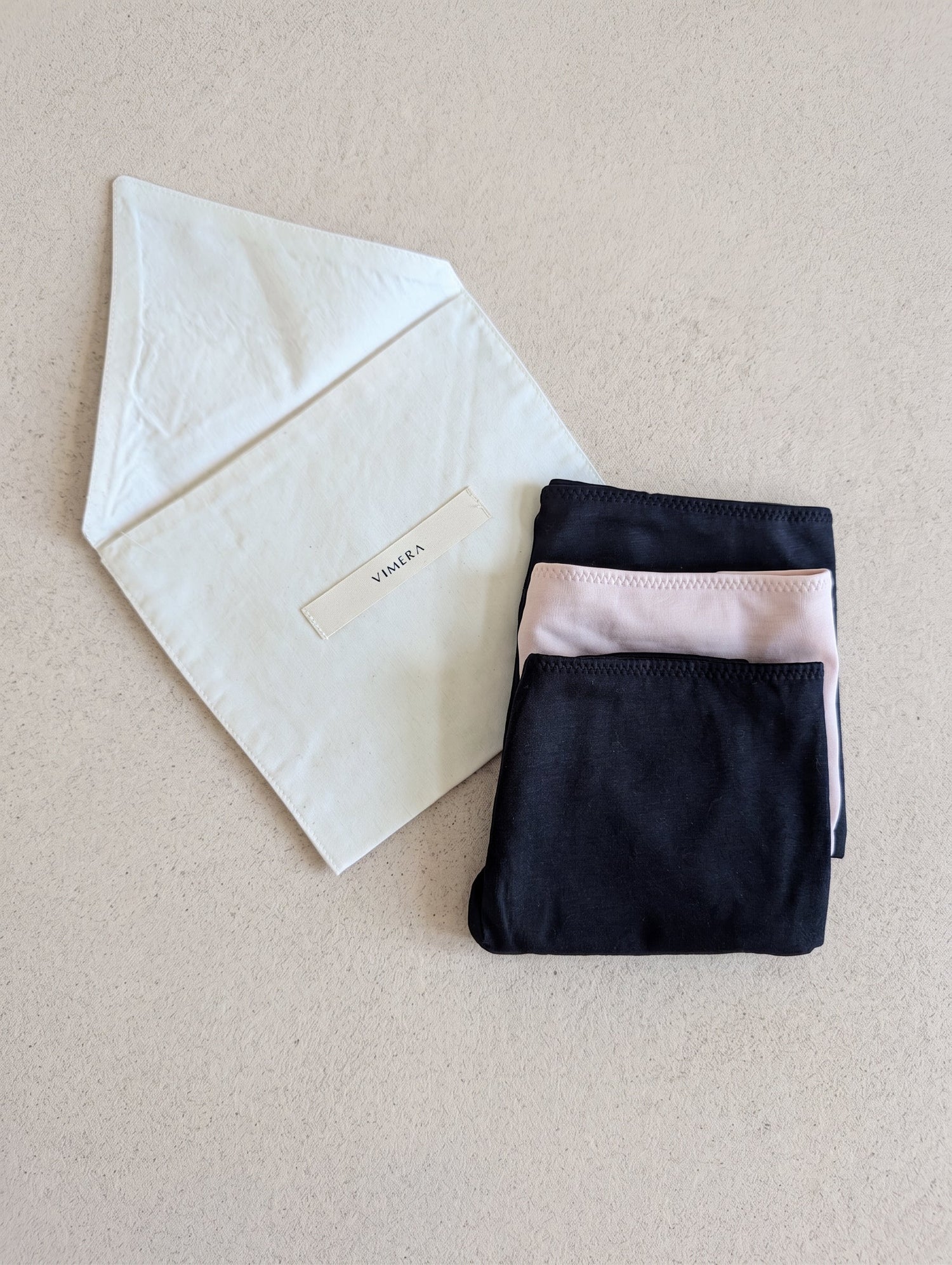 VIMERA organic Peruvian Pima cotton underwear in Noir and Bare beside raw cotton envelope.